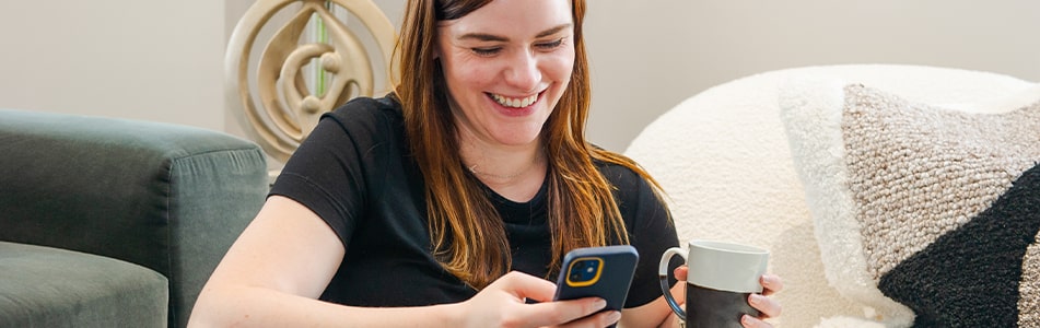 A lady on her phone smiling