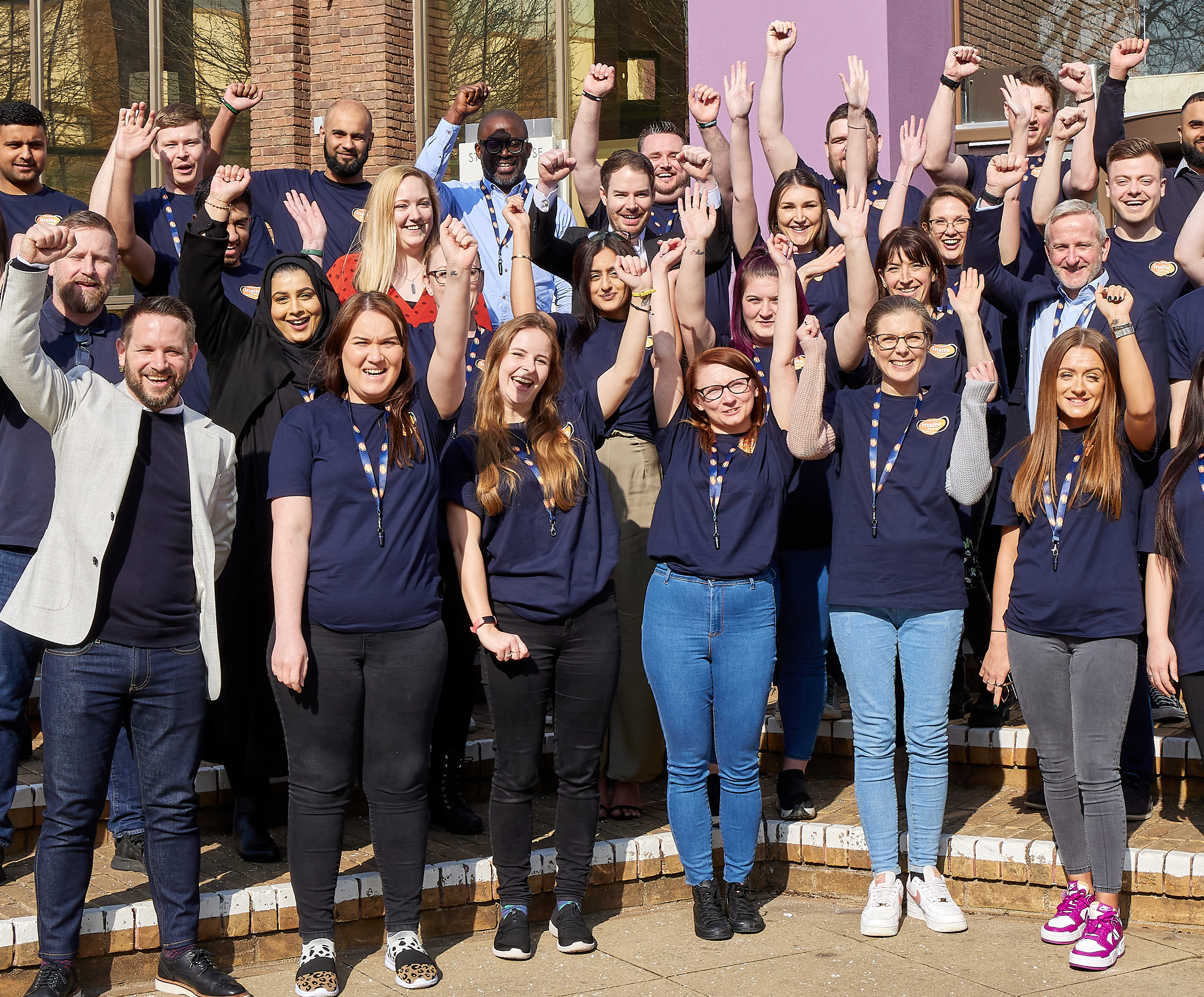 The Insite Energy team raising their hands and smiling